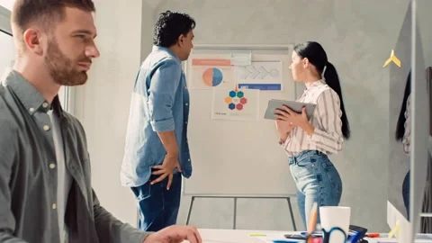 Man Working on Pc in Creative Office. Team Discussing Presentation in Office Stock Footage 217420583