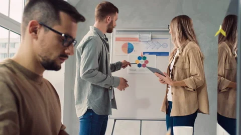 Man Working on PC in Creative Office. Girl and Man Discussing Presentation in Stock Footage 217835196