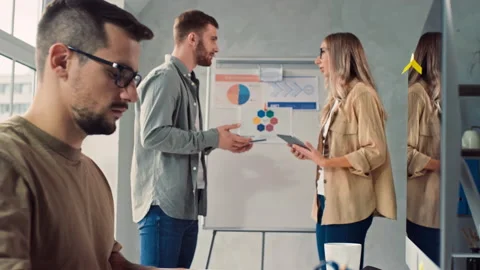 Man Working on PC in Creative Office. Girl and Man Discussing Presentation in Stock Footage 230020596