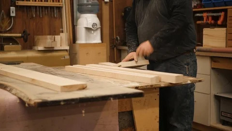 Man working with pieces of wood in workshop Stock Footage 102045264