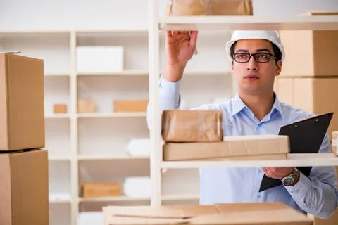 Man working in postal parcel delivery service office 스톡 사진
