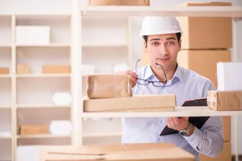 Man working in postal parcel delivery service office Stock Photos