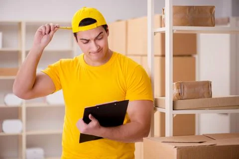 Man working in postal parcel delivery service office 写真素材