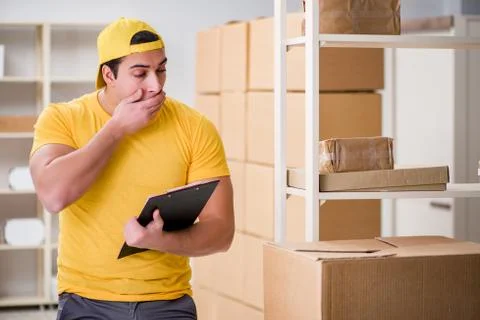 Man working in postal parcel delivery service office 写真素材