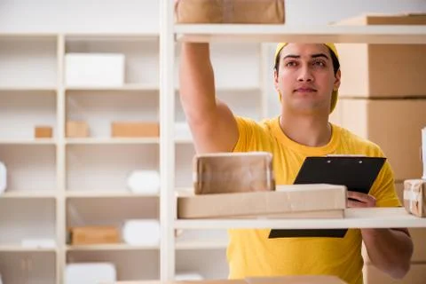 Man working in postal parcel delivery service office 写真素材