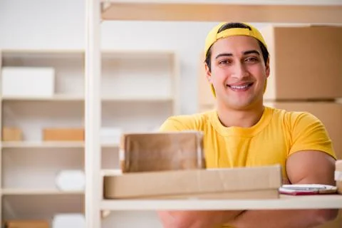 Man working in postal parcel delivery service office 스톡 사진