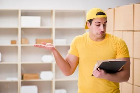 Man working in postal parcel delivery service office 스톡 사진