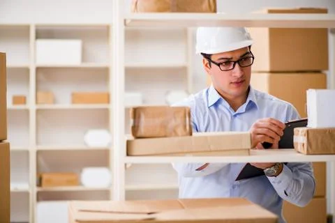 Man working in postal parcel delivery service office 写真素材