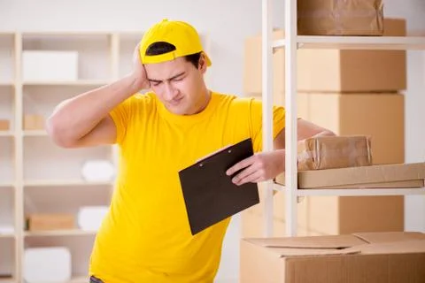 Man working in postal parcel delivery service office 写真素材