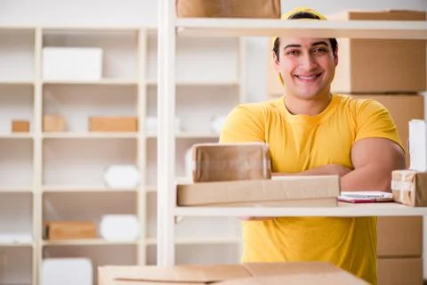Man working in postal parcel delivery service office 스톡 사진