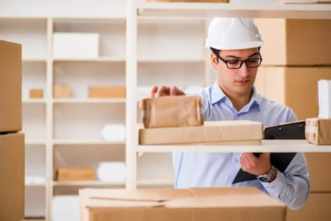 Man working in postal parcel delivery service office 写真素材