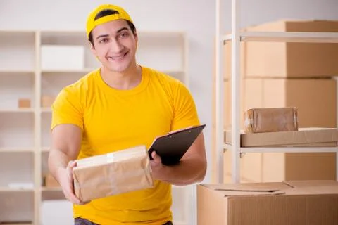 Man working in postal parcel delivery service office 스톡 사진