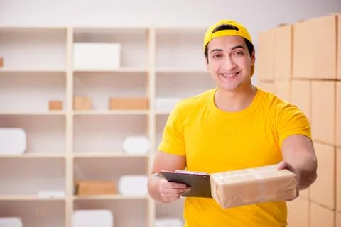 Man working in postal parcel delivery service office 스톡 사진