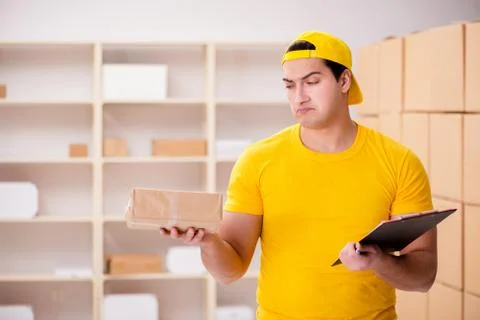 Man working in postal parcel delivery service office 写真素材