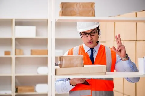 Man working in postal parcel delivery service office 写真素材