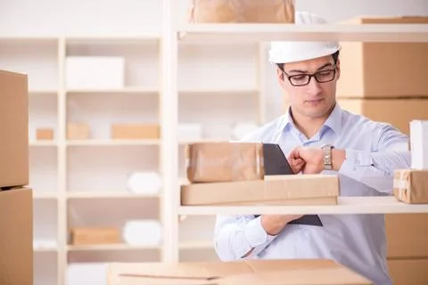 Man working in postal parcel delivery service office 스톡 사진