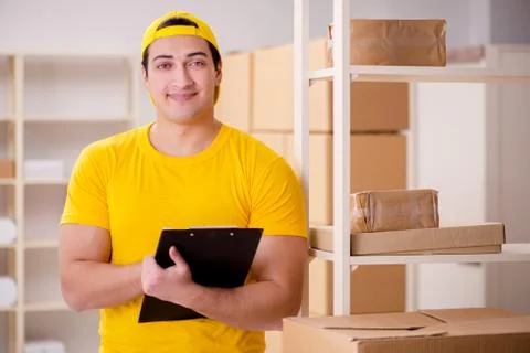 Man working in postal parcel delivery service office 스톡 사진
