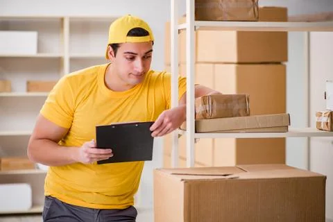 Man working in postal parcel delivery service office 스톡 사진
