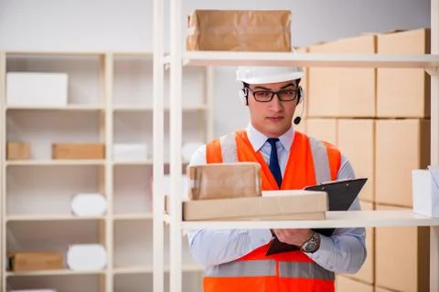 Man working in postal parcel delivery service office 스톡 사진