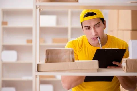 Man working in postal parcel delivery service office 写真素材