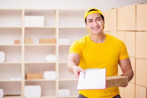 Man working in postal parcel delivery service office 스톡 사진
