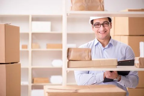 Man working in postal parcel delivery service office 스톡 사진