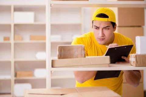Man working in postal parcel delivery service office 스톡 사진