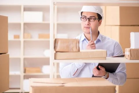 Man working in postal parcel delivery service office Stock Photos