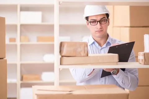 Man working in postal parcel delivery service office 写真素材