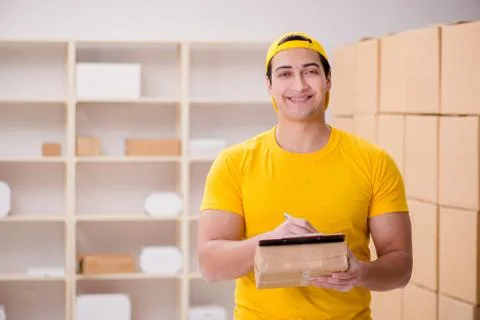 Man working in postal parcel delivery service office 스톡 사진