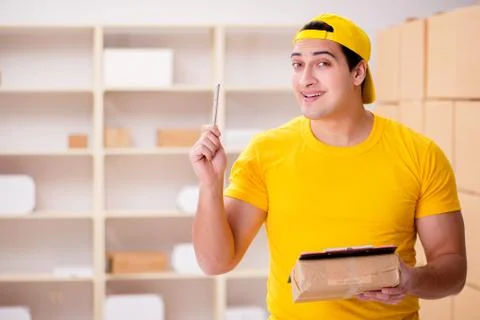 Man working in postal parcel delivery service office 스톡 사진