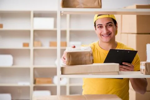 Man working in postal parcel delivery service office 스톡 사진