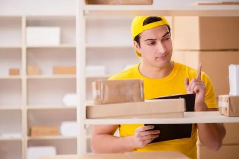 Man working in postal parcel delivery service office 스톡 사진