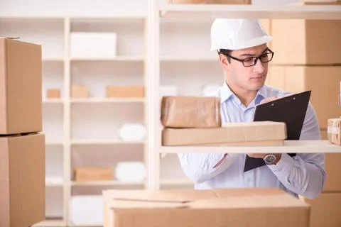 Man working in postal parcel delivery service office 写真素材