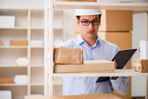 Man working in postal parcel delivery service office 스톡 사진