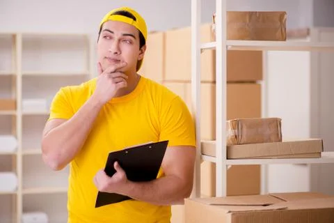 Man working in postal parcel delivery service office 스톡 사진