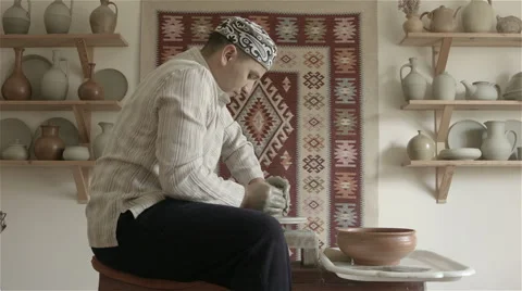 Man working on pottery wheel, shaping a clay pot Video stock 68049838