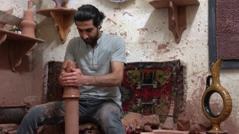 Man working on the pottery wheel in the workshop Stock Footage 201100870