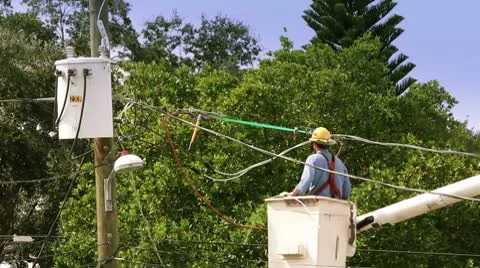 Man working on power lines from a bucket lift Stock Footage