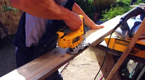 Man working with a power tool on wood Видео 64075312