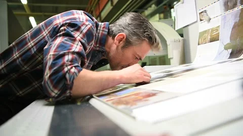 Man working in printing house Stock Footage 59774398