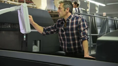 Man working in printing house Stock Footage 59784090