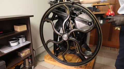 Man working on a printing press Stock Footage 66606513