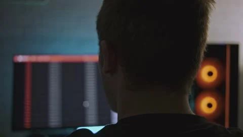 Man is working at professional computer with backlight. Clip. Man is working at Stock Footage 278381947
