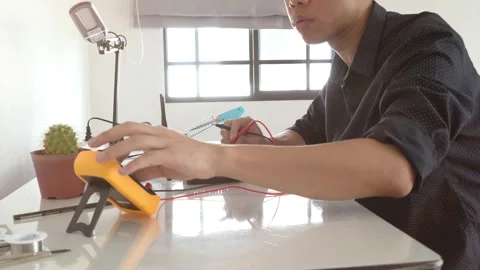 A man is working on a project on a table Stock Footage 315116175