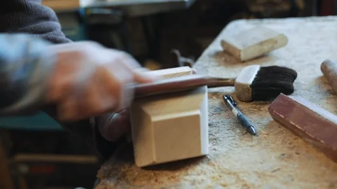A man is working on a project, using a hammer and a pair of scissors Stock Footage 301792981