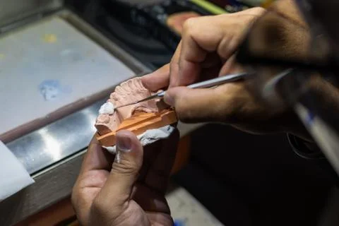 Man working in a prosthetic tooth close up Stock Photos