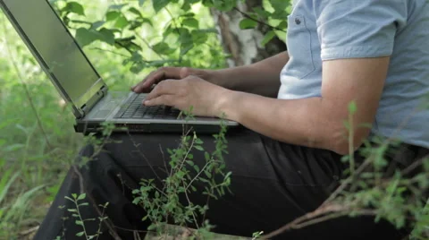 Man working remotely with laptop on the nature Stock Footage 63843793