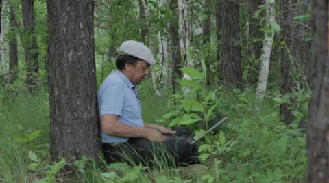 Man working remotely with laptop on the nature Stock Footage 63844541