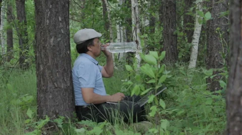 Man working remotely with laptop on the nature Stock Footage 63844542